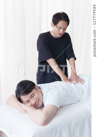 A chiropractor performing a treatment on a patient A chiropractor performing a treatment on a patient 127774584