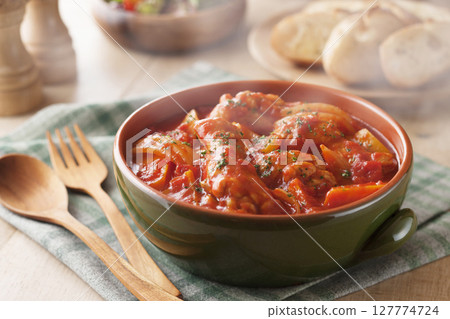 Chicken wings stewed in tomato sauce 127774724