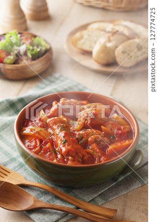 Chicken wings stewed in tomato sauce 127774725