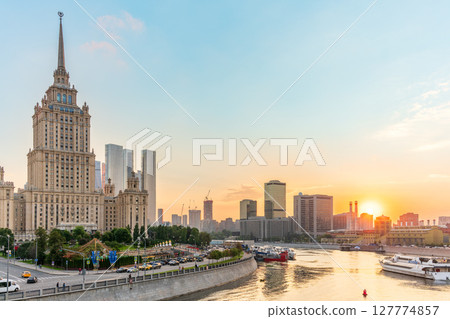High-rise stalinist building near river at summer sunset in Moscow, Russia. Historic name is Hotel Ukraine. 127774857