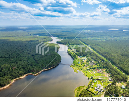 Aerial view of lake or river green shore with forest. Summer season. 127775040