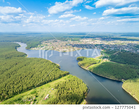 Aerial view of lake or river green shore with forest. Summer season. 127775041