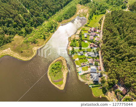 Aerial view of lake or river green shore with forest. Summer season. Aerial view of lake or river green shore with forest. Summer season. 127775044