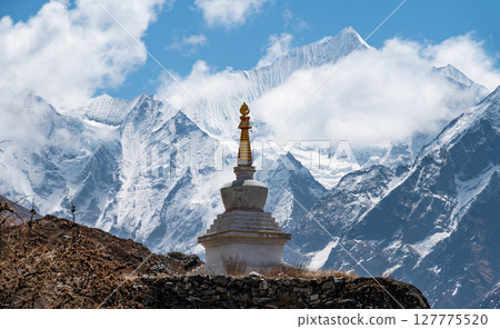 Tibetan Buddhist stupa on the way to Kyangjin Kharka village in Langtang National park in Nepal. The Langtang Valley is mainly inhabited by the Tamang people they mainly follow Tibetan Buddhism. Tibetan Buddhist stupa on the way to Kyangjin Kharka village in Langtang National park in Nepal. The Langtang Valley is mainly inhabited by the Tamang people they mainly follow Tibetan Buddhism. 127775520