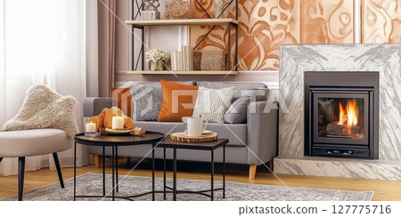 Warm and cozy living room featuring a fireplace and comfortable seating area 127775716