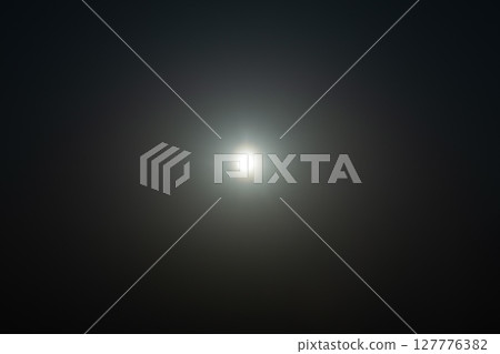 The sun shining in the sky, the flare reflected in it 127776382
