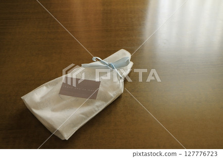 Gift in a white bag Gift in a white bag 127776723