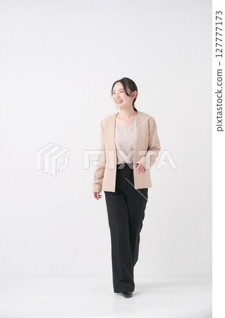 A woman in her 20s in a suit 127777173