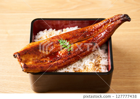A whole grilled eel on rice A whole grilled eel on rice 127777438