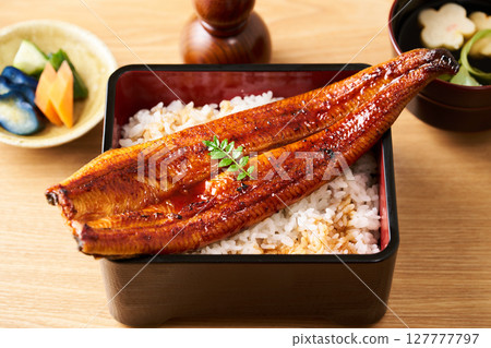 A whole grilled eel on rice A whole grilled eel on rice 127777797