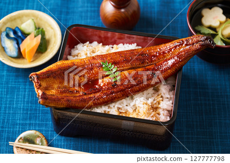 A whole grilled eel on rice A whole grilled eel on rice 127777798
