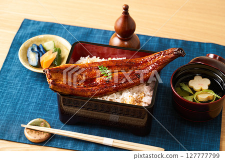 A whole grilled eel on rice A whole grilled eel on rice 127777799