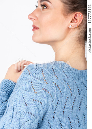 Beautiful woman studio portrait wearing blue sweater Beautiful woman studio portrait wearing blue sweater 127778161