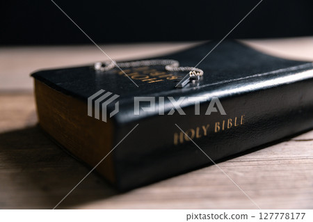 Religious belief concept Close up prayer Christian church service Bible Holy cross Spiritual power Blurred background Desk copy space Heaven God Catholic faith Praise book Jesus worship Gospel symbols Religious belief concept Close up prayer Christian church service Bible Holy cross Spiritual power Blurred background Desk copy space Heaven God Catholic faith Praise book Jesus worship Gospel symbols 127778177