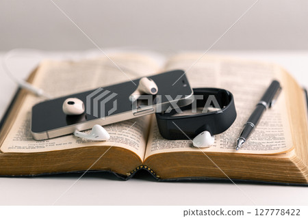 Close-up religious technology headphones pray bible church laptop Jesus Christ Holy Spirit Sunday service spiritual power blur background phone concept heaven belief gospel faith praise worship god Close-up religious technology headphones pray bible church laptop Jesus Christ Holy Spirit Sunday service spiritual power blur background phone concept heaven belief gospel faith praise worship god 127778422