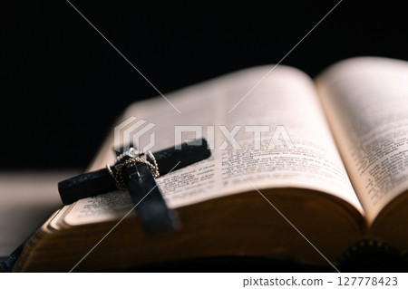 Religious belief concept Close up prayer Christian church service Bible Holy cross Spiritual power Blurred background Desk copy space Heaven God Catholic faith Praise book Jesus worship Gospel symbols 127778423