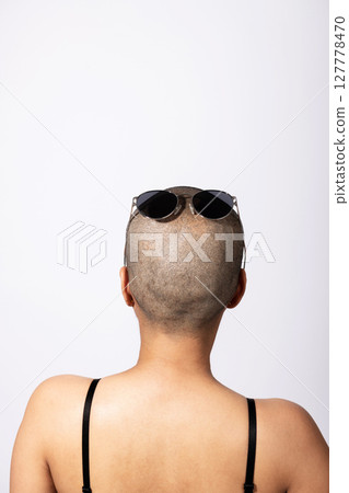 Woman with shaved head nape and back portrait with sunglasses on it Woman with shaved head nape and back portrait with sunglasses on it 127778470