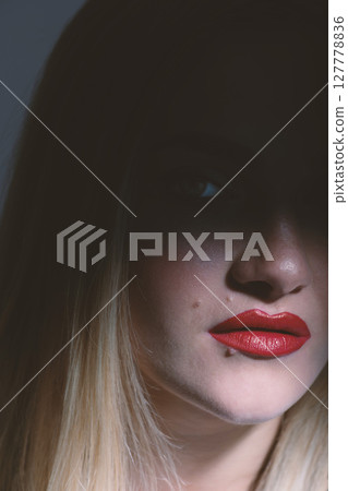 Beautiful woman portrait partly face covered with shadow Beautiful woman portrait partly face covered with shadow 127778836