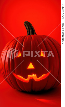 Halloween background with jack-o'-lantern on red backdrop 127778945