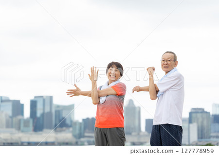 Senior men and women exercising 127778959