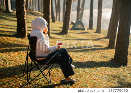 Business concept of cafe focuses on nurturing coffee in harmony with nature, organic seed create warm cup caffeine, background green fresh great outdoor. aromatic drink, rich aroma of rising from mug 127779080