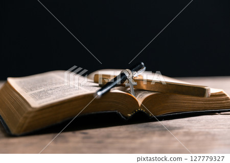 Religious belief concept Close up prayer Christian church service Bible Holy cross Spiritual power Blurred background Desk copy space Heaven God Catholic faith Praise book Jesus worship Gospel symbols Religious belief concept Close up prayer Christian church service Bible Holy cross Spiritual power Blurred background Desk copy space Heaven God Catholic faith Praise book Jesus worship Gospel symbols 127779327