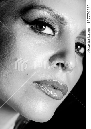 Beautiful young woman with classic make-up black and white studio portrait 127779381