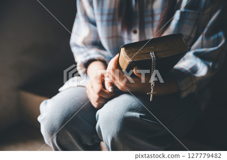 Christian woman reading bible in ancient Catholic temple. Reading Holy Bible in temple. Concept for faith, spirituality and religion. Peace, hope, Christians with holy book for worship and faith Christian woman reading bible in ancient Catholic temple. Reading Holy Bible in temple. Concept for faith, spirituality and religion. Peace, hope, Christians with holy book for worship and faith 127779482