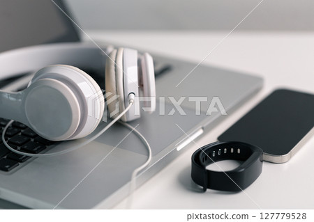 New technology modern Close up high resolution Wireless Earphones white Earbuds headphones black blur background Trendy minimal music device laptop concept phone accessories Comfortable Wooden table New technology modern Close up high resolution Wireless Earphones white Earbuds headphones black blur background Trendy minimal music device laptop concept phone accessories Comfortable Wooden table 127779528