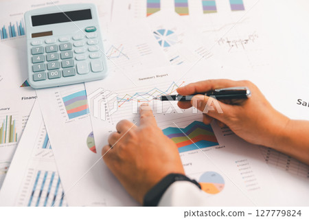 Business graph, chart on table. Financial development, banking account, statistic. Close up business people meeting to discuss situation on market. calculating investment. Business financial concept. 127779824