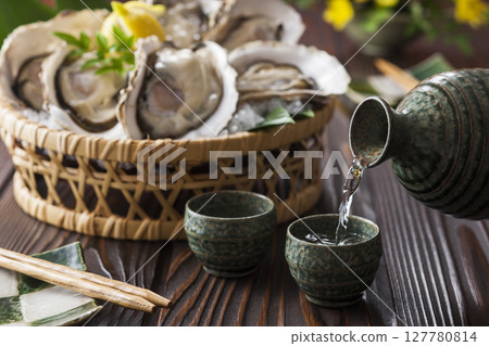 Sake and raw oysters 127780814