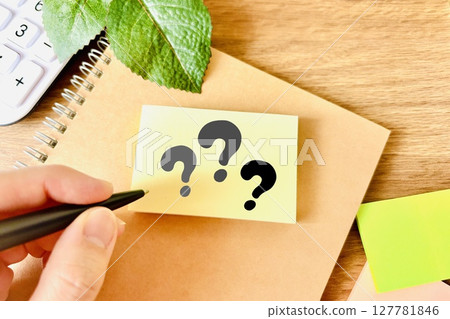 The hand of a person taking notes of questions 127781846