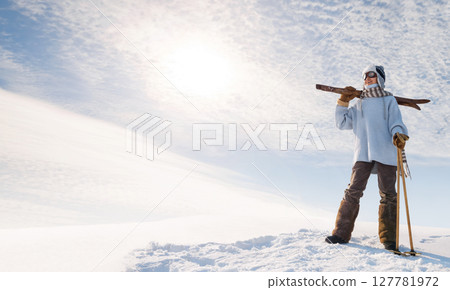 Boy on the old skis at the top of the hill. Boy on the old skis at the top of the hill. 127781972