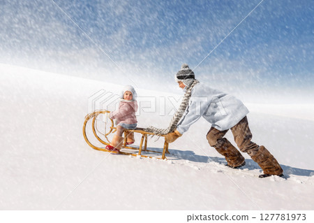 Children sled down the hill 127781973