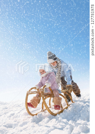 Children sled down the hill 127781978