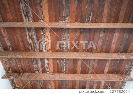Rustic old wood ceiling with support beams inside home during major renovation project. natural grain and weathered texture of wood create warm nostalgic feeling Rustic old wood ceiling with support beams inside home during major renovation project. natural grain and weathered texture of wood create warm nostalgic feeling 127782064