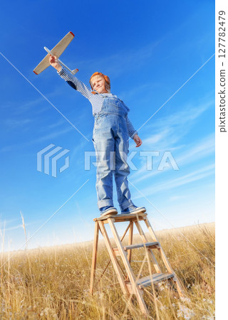 Little boy imagines flying. Little boy imagines flying. 127782479