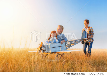 Little boys and girl is playing the plane. 127782492