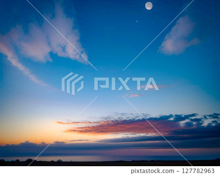 Sunset sky with the moon floating, clouds stretching to the horizon 2 Sunset sky with the moon floating, clouds stretching to the horizon 2 127782963