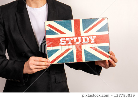 Person Holding British Flag Sign with Word Study Promoting English Language Learning Person Holding British Flag Sign with Word Study Promoting English Language Learning 127783039