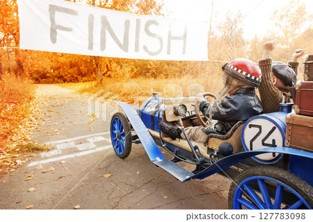 Young racer and mechanic on old race car Young racer and mechanic on old race car 127783098