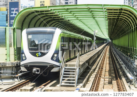 A Green Line train running on the elevated track of the Taichung Rapid Transit System in Taiwan.  127783407