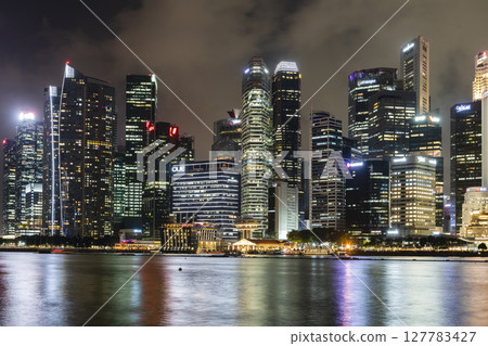 Night view of the Marina Bay Financial Centre and the Raffles Place modern office skyscrapers along Marina Bay in Singapore.  127783427
