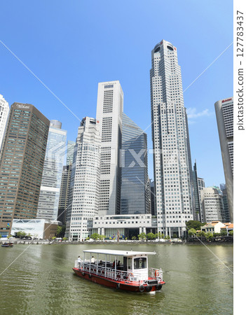 Panoramic view of the Sightseeing Bumboats cruising on the Singapore River and the Financial District skyscrapers along the shore. Panoramic view of the Sightseeing Bumboats cruising on the Singapore River and the Financial District skyscrapers along the shore. 127783437