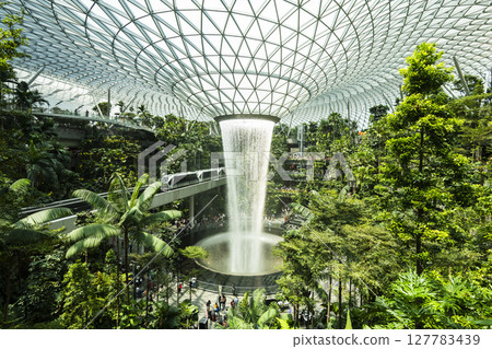 View of HSBC Rain Vortex at Jewel Changi Airport, Singapore. It is the world's largest and tallest indoor artificial waterfall, surrounded by a terraced forest. View of HSBC Rain Vortex at Jewel Changi Airport, Singapore. It is the world's largest and tallest indoor artificial waterfall, surrounded by a terraced forest. 127783439
