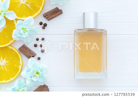 Citrus Scented Perfume Bottle Surrounded by Flowers and Oranges Citrus Scented Perfume Bottle Surrounded by Flowers and Oranges 127785539