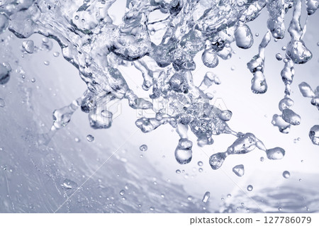 Water splashes on a blue background. Water splashes on a blue background. 127786079