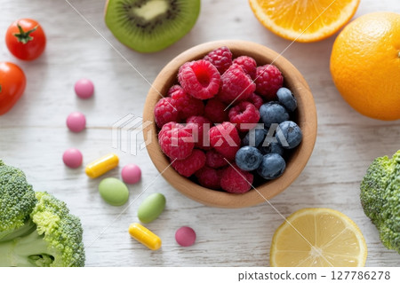 Fresh Fruits and Colorful Vegetables Arranged on a Wooden Surface 127786278