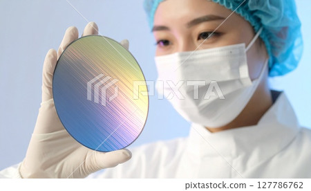 Close-up image of a woman visually inspecting wafers in a semiconductor manufacturing plant Close-up image of a woman visually inspecting wafers in a semiconductor manufacturing plant 127786762