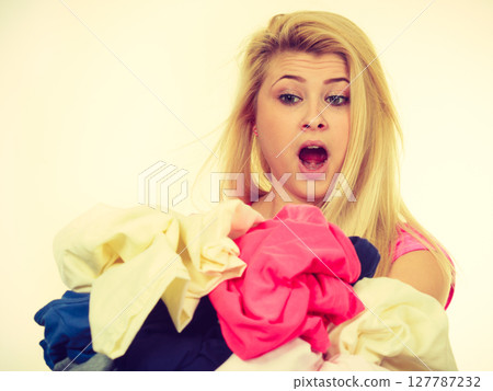Woman having creased clothes to iron 127787232